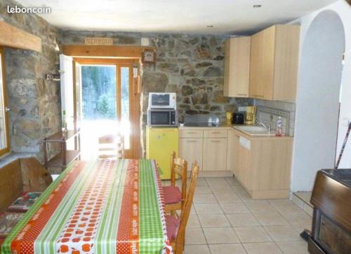 a kitchen with a table with a tablecloth on it at Appartement Chalet Nerboux in Morillon