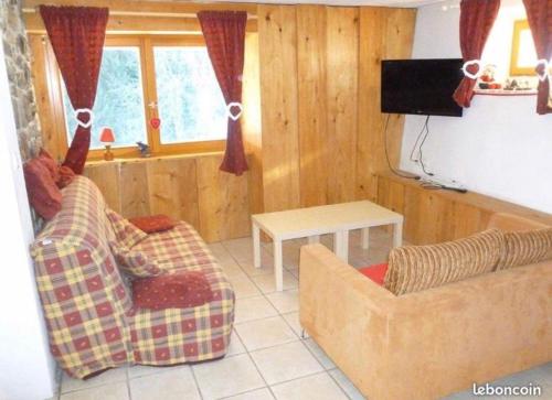 a living room with two couches and a flat screen tv at Appartement Chalet Nerboux in Morillon