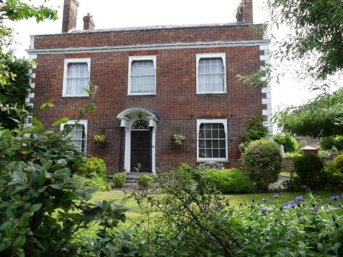 an old red brick house with a black door at Milford Hall Salisbury in Salisbury