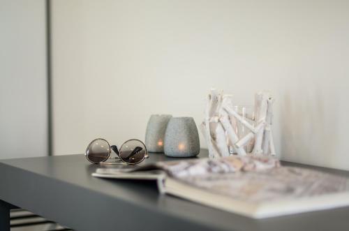 a black table with glasses and vases on it at Lianos Village in Agios Prokopios