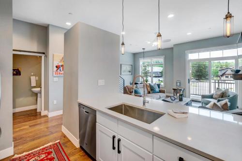 a kitchen with a sink and a living room at New Luxury Loft #10 - Huge Hot Tub & Great Views - 500 Dollars Of FREE Activities & Equipment Rentals Daily in Winter Park