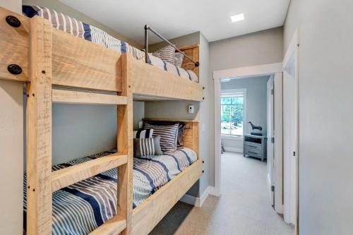 a bunk bed in a room with two beds at New Luxury Loft #10 - Huge Hot Tub & Great Views - 500 Dollars Of FREE Activities & Equipment Rentals Daily in Winter Park
