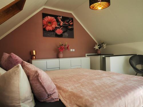 a bedroom with a bed and flowers on the wall at Ferienhaus Elsa in Kranichfeld