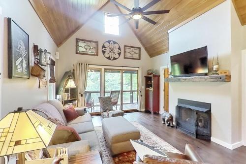 a living room with a couch and a fireplace at at E's in Cullowhee
