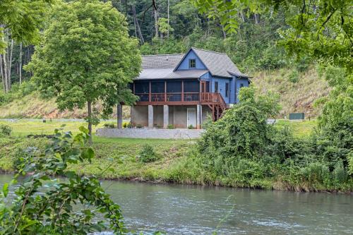 a blue house on the side of a river at at E's in Cullowhee