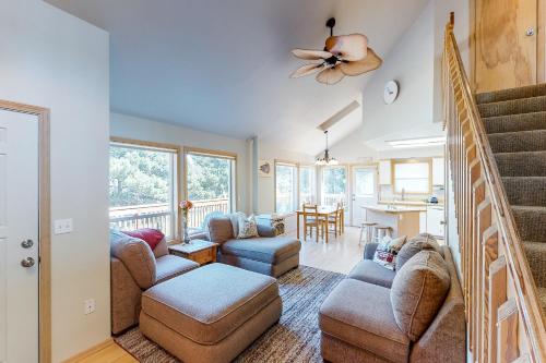 a living room with a couch and chairs and a staircase at Tanya's Beach Retreat in Pacific City