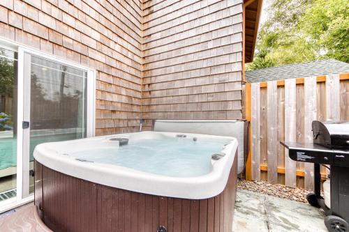 a bath tub sitting on a patio next to a window at Lake & Ocean in Rockaway Beach