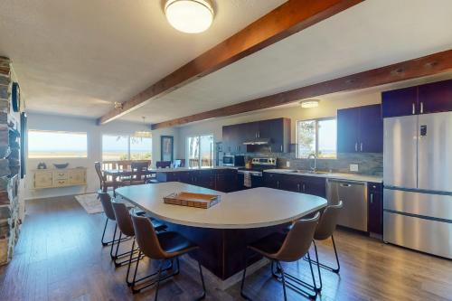 a large kitchen with a table and chairs in it at Baydream in Westport