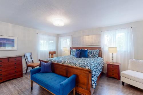 a bedroom with a bed and a blue chair at Baydream in Westport