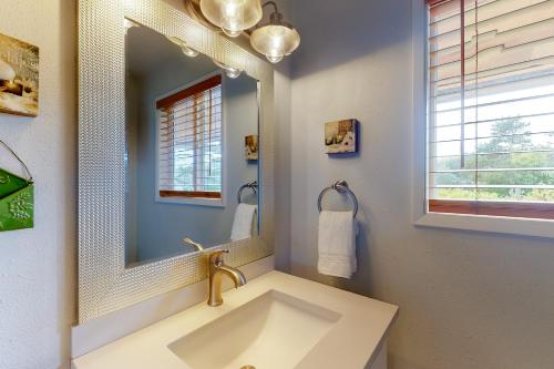 a bathroom with a sink and a mirror at Baydream in Westport