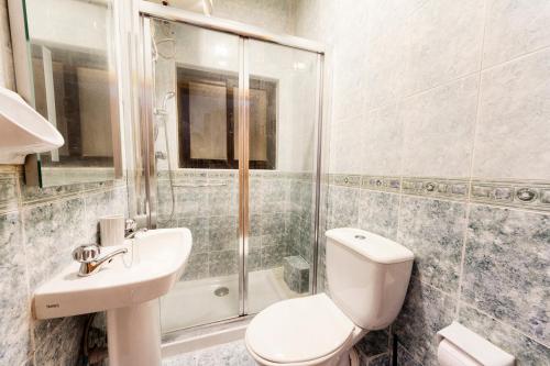 a bathroom with a toilet and a sink and a shower at Central 3 Bedroom Entire Apartment Msida in Msida