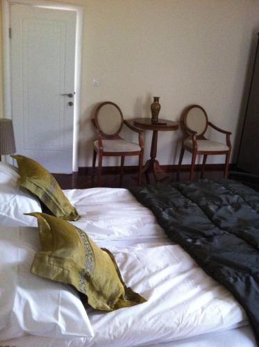 a bed with pillows on it in a bedroom at Sunny House in Skopje