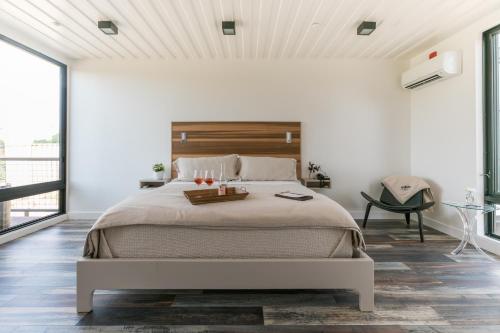 a bedroom with a large bed with a wooden headboard at Geneseo Inn in Paso Robles