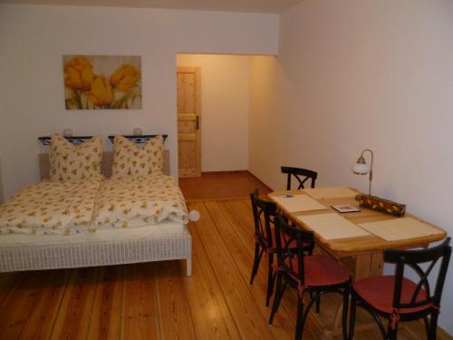 a bedroom with a bed and a table with chairs at Fahrradpension-Joachimsthal in Joachimsthal