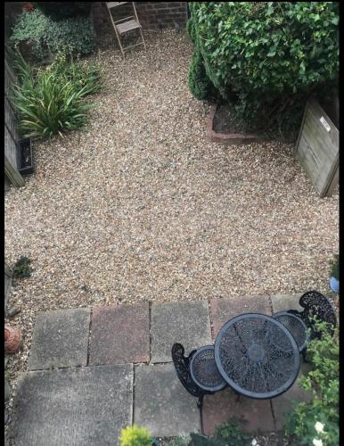 a garden with a table and some rocks and plants at Attractive 2 bed cottage in Hempton Fakenham in Fakenham