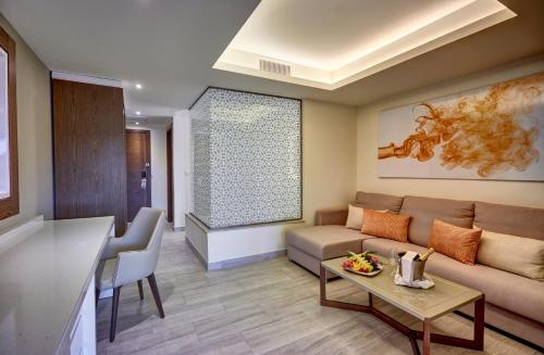 a living room with a couch and a table at Royalton Bavaro, An Autograph Collection All-Inclusive Resort & Casino in Punta Cana