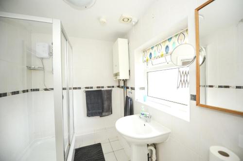 a bathroom with a sink and a toilet and a shower at Maryland in Derby