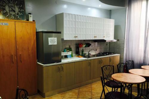 a kitchen with white cabinets and a table and chairs at Legend R.G. in Rome