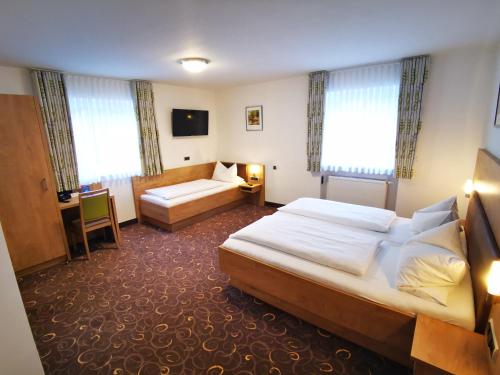 a hotel room with a bed and a couch at Gasthof Endres in Allersberg