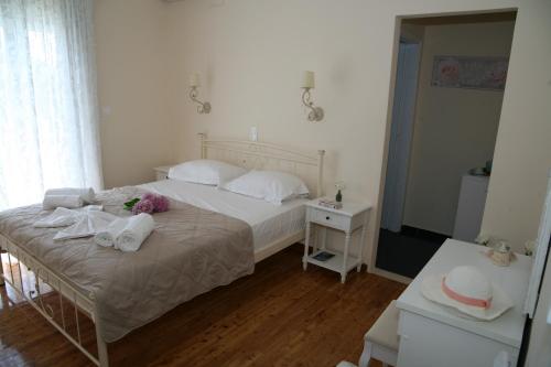 a bedroom with a bed with towels on it at Terpsichore Boutique Appartments in Dassia