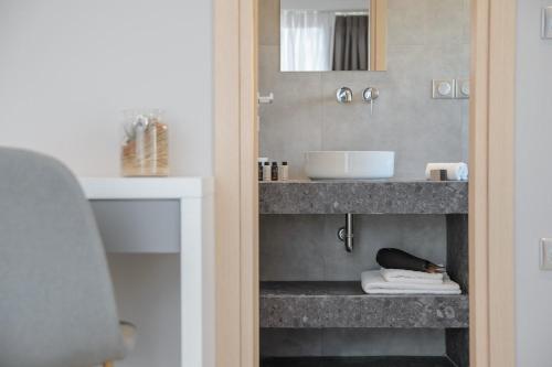 a bathroom with a sink and a counter at The Convo Syngrou Apartments in Athens