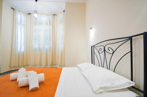 a bedroom with a black and white bed with white sheets at Athens Psiri Hotel in Athens