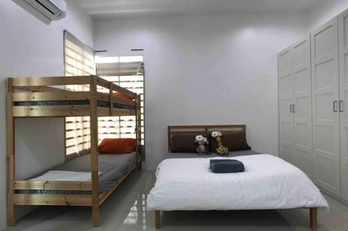 a bedroom with two bunk beds and a ladder at be.Animania -8-10mins Lost World Tambun -14-18pax in Ipoh
