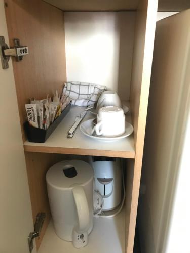 a cupboard with a sink and a toilet in it at Westside Motor Inn in Sydney