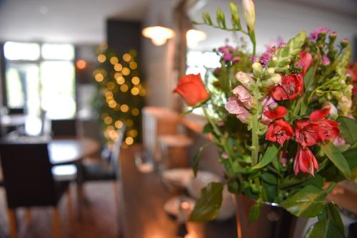 a vase filled with flowers on a table at Maryland in Derby