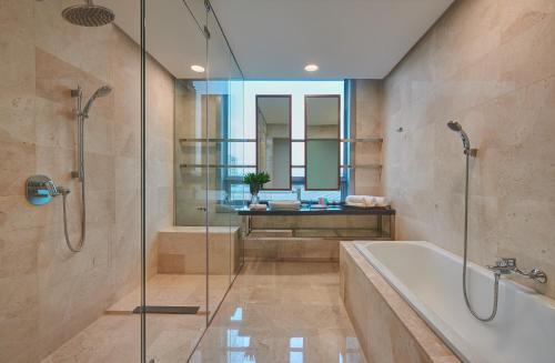 a bathroom with a shower and a tub and a sink at St Giles Boulevard in Kuala Lumpur