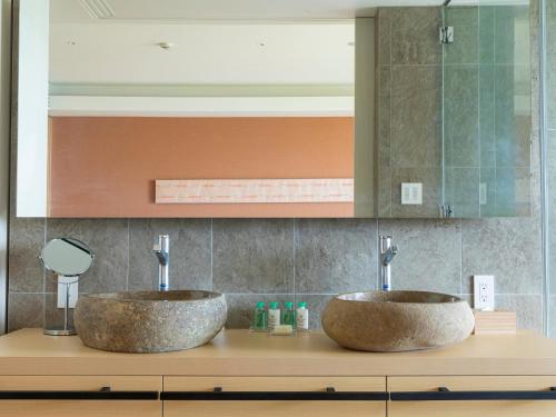 two sinks on top of a counter in a bathroom at Garden Terrace Fukuoka in Fukuoka