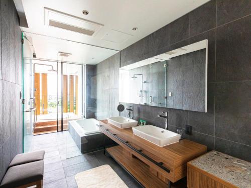 a bathroom with two sinks and a mirror at Garden Terrace Fukuoka in Fukuoka