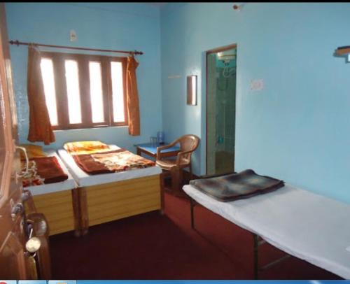 a bedroom with a bed and a window and a mirror at Hotel SHREE Uttarkashi in Uttarkāshi