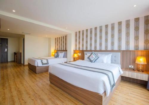Cama o camas de una habitación en UMI-PQ hotel