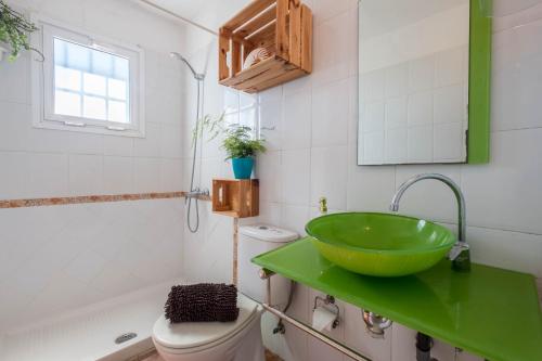 a bathroom with a green sink and a toilet at Casa Tabaiba - Villa Perenquén in Guía de Isora