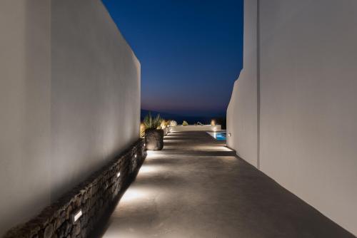 a hallway of a building with a blue sky at Volcanic Arc Suites in Oia