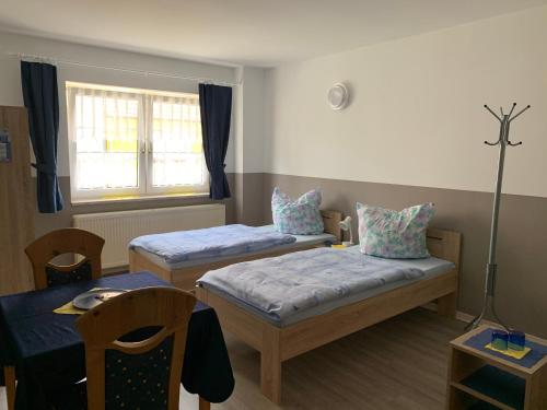 Postel nebo postele na pokoji v ubytování BOARDINGHOUSE ORANIENBURG