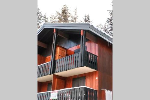 a building with balconies on the side of it at appartement en chalet au pied des pistes in La Norma