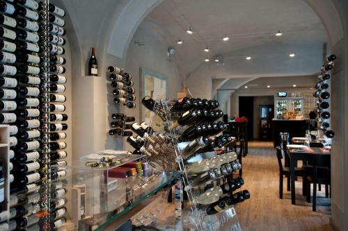 a room with a bunch of wine bottles on a shelf at Vinoteca La Sacrestia in Alba