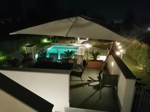 an umbrella on the balcony of a house at night at Il Toscanello in Lido di Camaiore