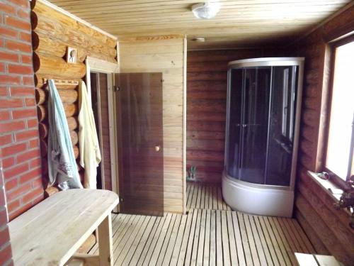 a screened in porch with a large window and a bench at Viesu māja Manturi in Piepeni