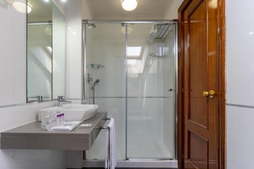 a bathroom with a sink and a shower at Chateau La Roca in Sancibrián