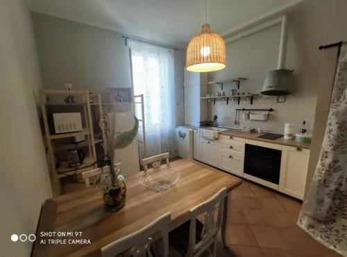 a kitchen with a table with a vase on it at Villa Blanco's in Morciano di Romagna