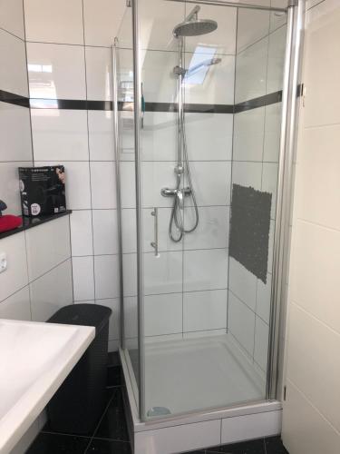 a shower with a glass door in a bathroom at Apartment mit Parkblick in Tönisvorst
