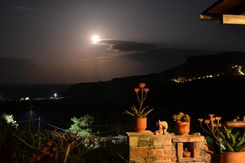 a full moon rising over the ocean at night at Katerina Apartments in Káto Zákros