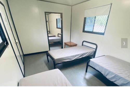 a hospital room with two beds and a mirror at Lions Camp Kanga in Dittmer