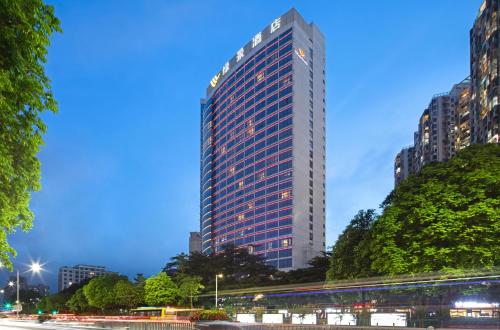 a tall building in a city at night at Shenzhen L.gem Hotel in Shenzhen