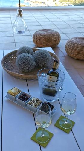 a table with two glasses and a bottle of wine at Villa Estée, luxury villa with private infinity pool and jacuzzi in Elounda
