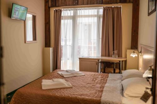 Кровать или кровати в номере Отель Атлантик
