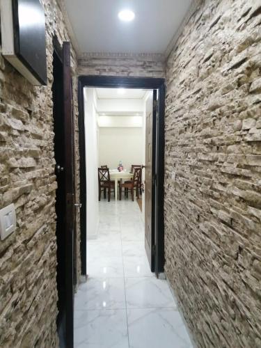 a hallway leading to a dining room with a stone wall at Saraya Eltram-families only in Alexandria